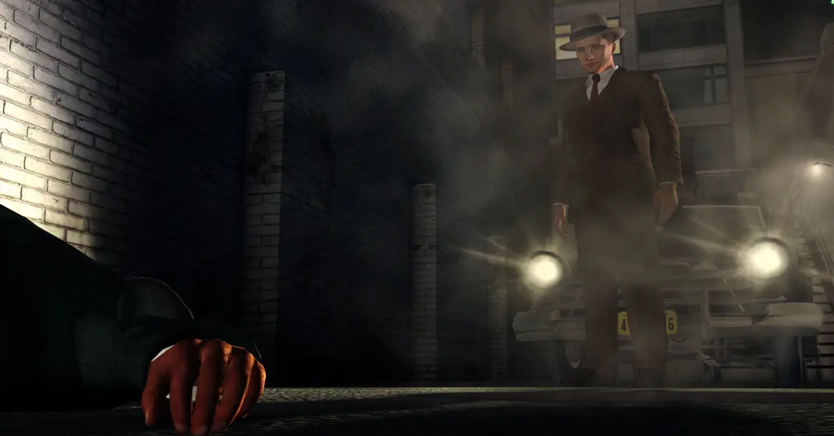 L.A. Noire detective Cole Phelps standing in a dimly lit 1940s street