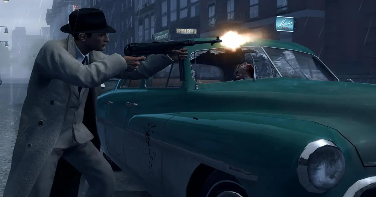 Vito Scaletta taking cover behind a classic car during a gunfight in Mafia II: Definitive Edition