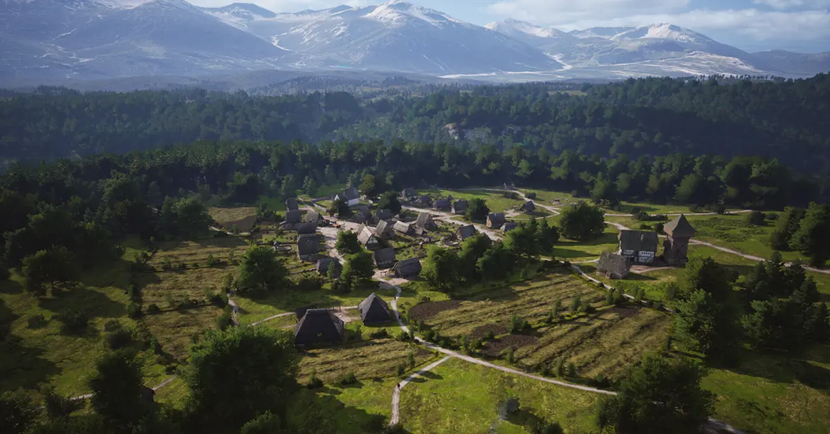 Close-up of a manor house and surrounding fields in Manor Lords.