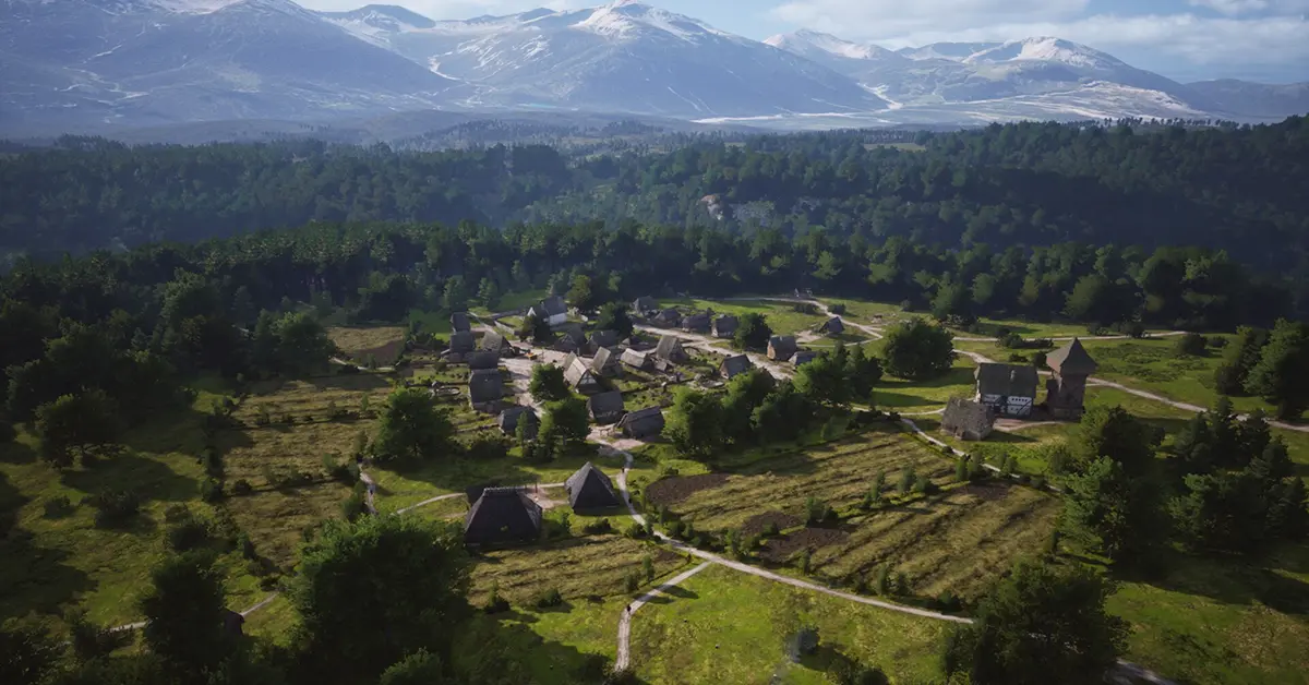 A sprawling medieval settlement in Manor Lords showing complex city building and military units.